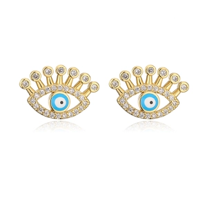 Detail of gold evil eye stud earrings with blue enamel and sparkling crystal stones
