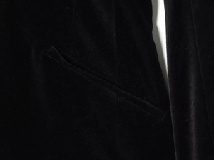 Detailed close-up of side pocket on black velvet V-neck short blazer romper for women