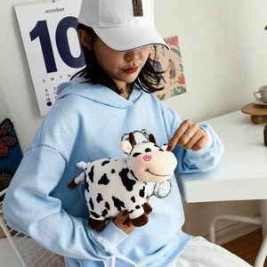 Cute plush cow crossbody bag with black spots and soft shoulder straps for kids