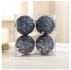 Detailed view of four navy blue Christmas ornaments with silver stars in a clear box
