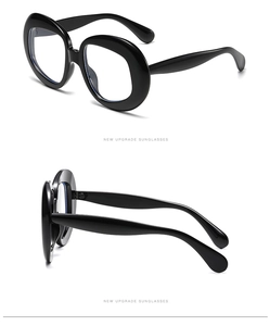 Detail view of bold black oversized round frames with premium resin polished finish