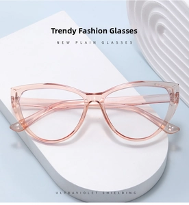 Detail of pink cat-eye glasses frame with blue light blocking lens on a white pedestal