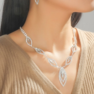 Elegant silver bridal jewelry set with sparkling marquise and round crystals on a model
