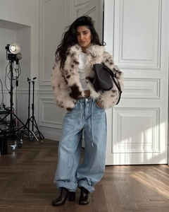 Full street style view of a faux fur animal print coat and wide-leg blue jeans outfit