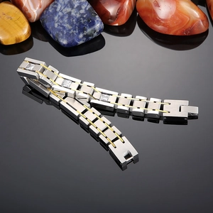 Macro view of men's titanium bracelet with two-tone finish and inset square diamonds