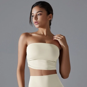 Detail of ruched side seam on cream strapless sports bra with high-elastic fabric
