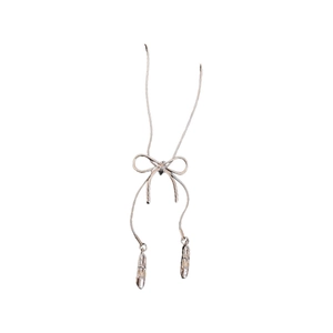 Silver balletcore necklace with ribbon bow and ballet shoes pendants on white background
