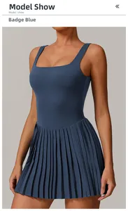 Detail of square neck Badge Blue pleated tennis dress with premium matte texture