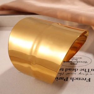 Polished gold wide open cuff bracelet with irregular minimalist design and mirror finish