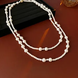 Elegant multi-layered pearl necklace with gradient bead sizes on a black velvet jewelry box