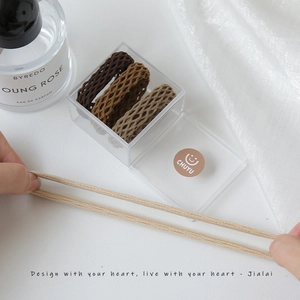 Three earth-toned high-elasticity mesh hair ties with a clear acrylic storage box