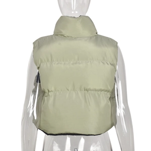 Detail of light green glossy quilted puffer vest with stand collar and horizontal stitching