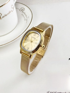 Elegant gold oval quartz watch with Milanese mesh band shown in a premium lifestyle setting