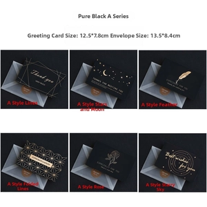 Detail of elegant black greeting cards with gold foil designs and envelopes