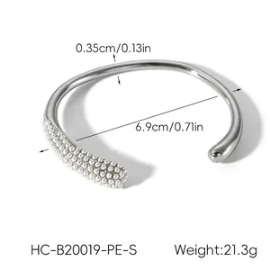 Macro detail of silver-finish steel bangle showing 0.35cm width and pearl clusters