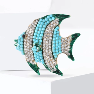 Elegant gold-tone tropical fish brooch with blue beads and white rhinestones