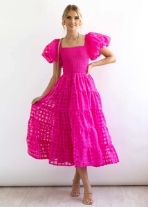 Detail of fuchsia off-shoulder bubble sleeves and textured smocked bodice on dress