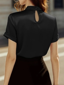 Detail of black satin short sleeve shirt with high collar and back teardrop button closure
