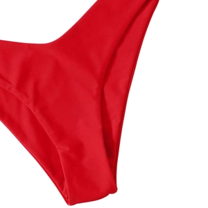 Detail of red bikini bottom showing high-cut leg opening and precise seamless stitching