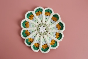 Detailed view of handmade crochet flower coaster in multi-color gradient soft cotton yarn