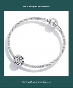 Macro detail of silver mesh bracelet with hollow flower charm and Forever Love clasp
