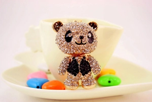 Close-up of a panda keychain featuring gold-tone metal and sparkling rhinestone detailing