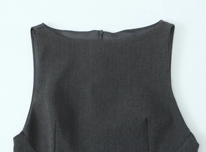 Detail of dark grey sleeveless dress neckline featuring premium fabric and hidden back zipper