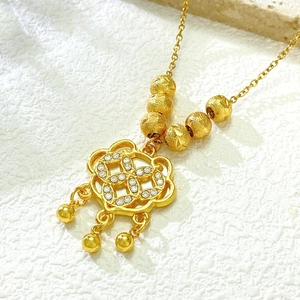 Detailed macro of gold Ruyi lock necklace with white zircon inlays and star carved beads
