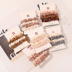 Detail view of 18-piece satin scrunchies set in elegant Morandi colors on display cards
