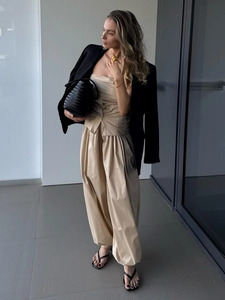 Detail of cotton harem pants with waist pleats and cinched cuffs in a minimalist outfit