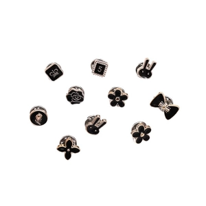 Set of 10 gold-trimmed black enamel pins featuring classic crown and rose motifs