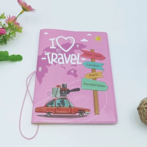 Pink passport cover featuring embossed I LOVE TO TRAVEL text and city names in a flat lay view