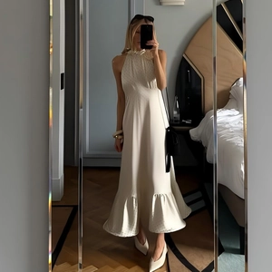 Chic white halter neck satin dress with ruffled hem and sexy backless detail