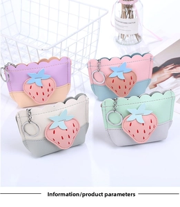 Close-up of strawberry coin purse with leather texture and metal keychain ring
