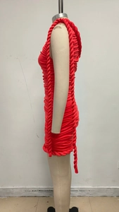 Detail of red ruched bodycon dress showing thick decorative braided rope on the side