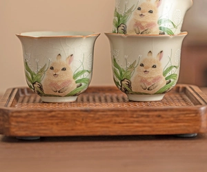 Close-up of Ru Kiln ceramic tea cup featuring hand-painted rabbit and crackle glaze