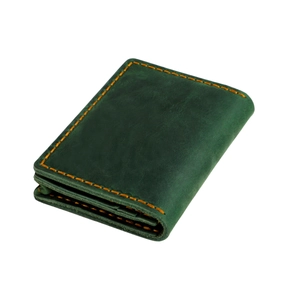 Macro shot of dark green crazy horse leather card holder with yellow stitching
