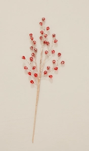 Close-up of deep red artificial berry branch with festive gold glitter for DIY decor