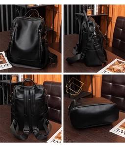 Detail view of black faux leather backpack showing pebbled texture and tassel zippers