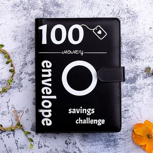 Black PU leather 100 Envelope Savings Challenge binder on marble background