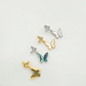 Set of four 18K gold plated butterfly pendants with shell inlays on white background