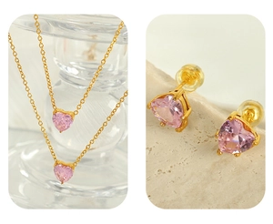 Detail of pink heart-shaped crystal pendant necklace and matching gold stud earrings