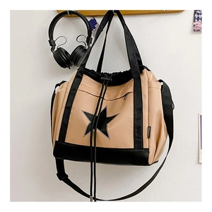 Detail of khakhi and black drawstring tote bag with star logo and adjustable shoulder strap