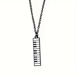 Black metal necklace featuring a long piano keyboard pendant with enamel keys for musicians