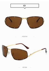 Detail of square gold metal sunglasses with brown lenses and side rhinestone accents