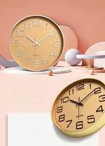 Close-up of modern round wall clocks with quartz movement in warm minimalist scene
