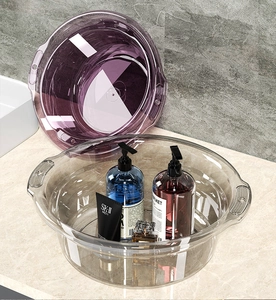 Close-up of thick transparent washbasins with ergonomic handles on marble bathroom counter