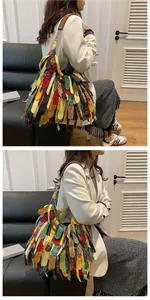 Detailed shot of bohemian patchwork tassel tote bag with colorful leather stripes