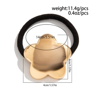 Detail of black elastic hair tie with golden star showing weight and dimensions info