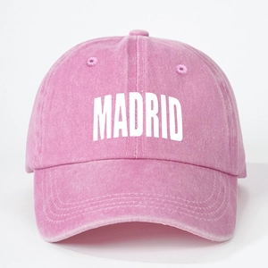 Close-up of pink washed cotton baseball cap featuring white MADRID letter print